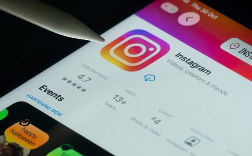 Dhaka, Bangladesh- 30 Oct 2025: Instagram app on a iPad screen with a pen pointing at the install