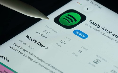 Dhaka, Bangladesh- 30 Oct 2025: Spotify app on a iPad screen with a pen pointing at the install