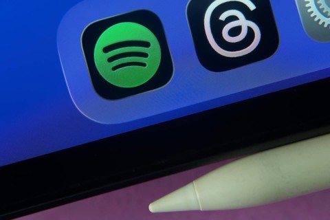 16 Nov 2025- Dhaka, Bangladesh: Spotify and other app icons with a digital pen on a iPad screen