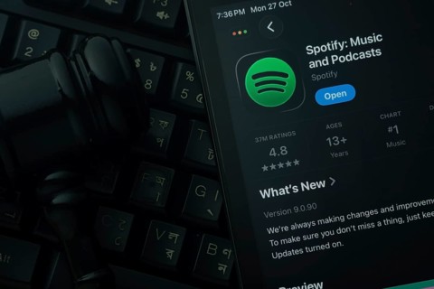 Dhaka, Bangladesh- 28 Oct 2025: An iPad displaying the Spotify app against a judge's gavel and dark
