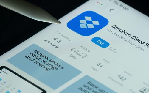 Dhaka, Bangladesh- 30 Oct 2025: Dropbox app on a iPad screen with a pen pointing at the install