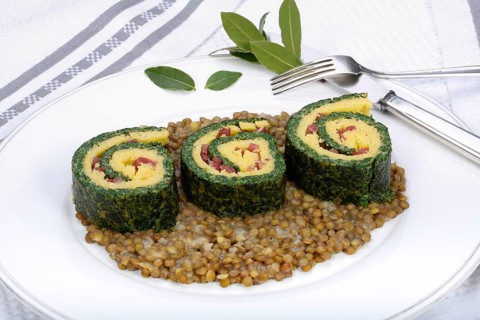 Southern German cuisine, polenta spinach roulade with alblentils served on serving platter, bay