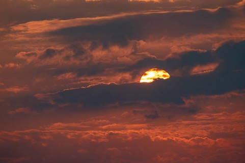 Dramatic sunset with clouds and sun, Etosha National Park, Namibia