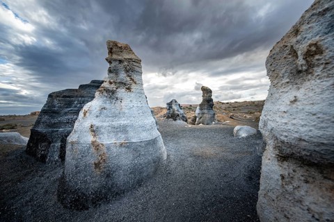 Eroded rock formations, volcanic landscape with dramatic cloudy skies, Ciudad Estratificada or Los