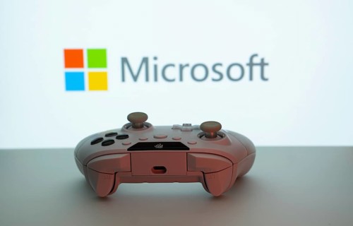 Dhaka, Bangladesh- 09 May 2025: A close-up of a white gamepad with the Microsoft seen on screen in