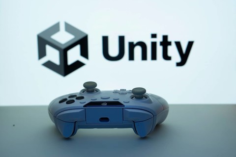 Dhaka, Bangladesh- 14 Nov 2025: A close-up of a white gamepad with the Unity seen on screen in the