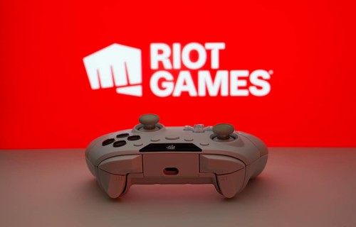Dhaka, Bangladesh- 14 Nov 2025: A close-up of a white gamepad with the Riot Games seen on screen in
