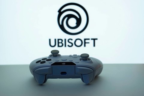 Dhaka, Bangladesh- 14 Nov 2025: A close-up of a white gamepad with the Ubisoft seen on screen in