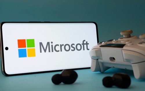Dhaka, Bangladesh- 23 Mar 2025: A smartphone with a Microsoft icon next to a controller and earbuds