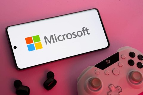 Dhaka, Bangladesh- 22 Mar 2025: Smartphone with Microsoft logo, game controller, and earbuds on a