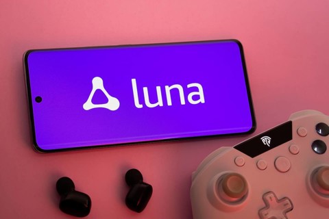 Dhaka, Bangladesh- 22 Mar 2025: Smartphone with Amazon Luna logo, game controller, and earbuds on a