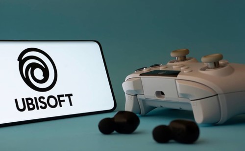 Dhaka, Bangladesh- 23 Mar 2025: A smartphone with a Ubisoft icon next to a controller and earbuds