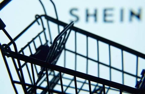 Dhaka, Bangladesh- 03 July 2025: Silhouette of a shopping cart in front of the SHEIN logo,