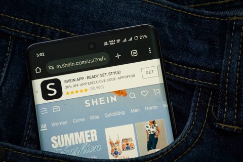Dhaka, Bangladesh- 15 June 2025: A smartphone displaying the SHEIN web interface peeks out of a