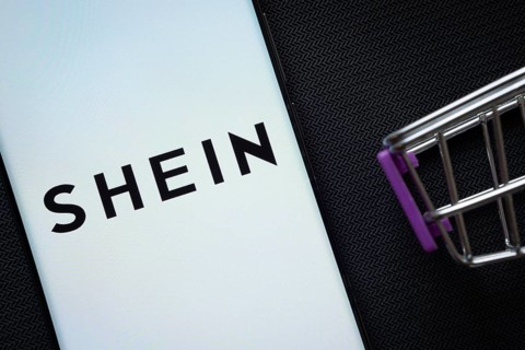 Dhaka, Bangladesh- 03 July 2025: A smartphone displaying the SHEIN logo next to a miniature