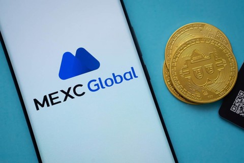 Dhaka, Bangladesh- 03 Sep 2025: MEXC Global logo on smartphone screen near Bitcoin coin and QR code