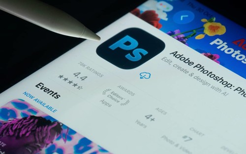 Dhaka, Bangladesh- 30 Oct 2025: Adobe Photoshop app on a iPad screen with a pen pointing at the