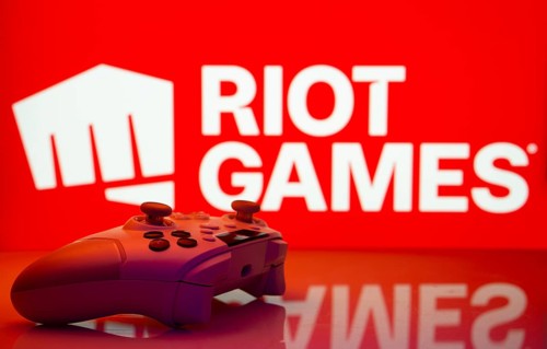 Dhaka, Bangladesh- 14 Nov 2025: A close-up of a white gamepad with the Riot Games seen on screen in