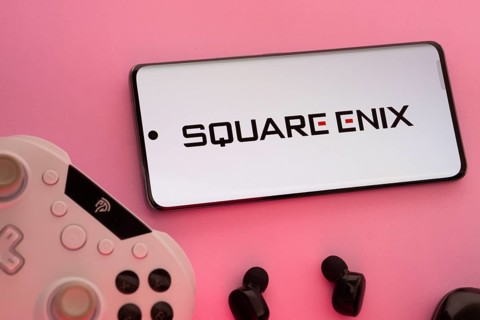 Dhaka, Bangladesh- 22 Mar 2025: Smartphone with Square Enix logo, game controller, and earbuds on a