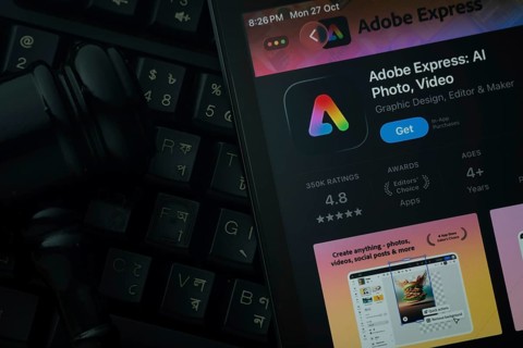 Dhaka, Bangladesh- 28 Oct 2025: An iPad displaying the Adobe Express app against a judge's gavel