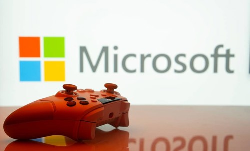 Dhaka, Bangladesh- 09 May 2025: A close-up of a white gamepad with the Microsoft seen on screen in