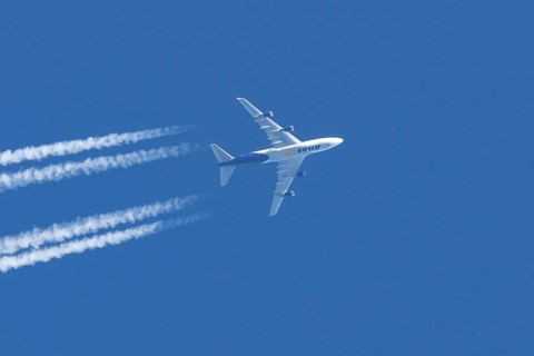 Boeing 747 jumbo jet cargo aircraft of Atlas air airlines flying in a blue sky with contrails or