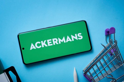 Dhaka, Bangladesh- 03 July 2025: Smartphone displaying Ackermans logo with shopping cart on a blue