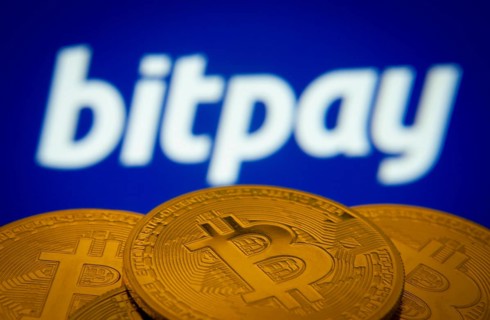 Dhaka, Bangladesh- 26 Aug 2025: Close-up of Bitcoin coins with the bitpay logo visible on a screen