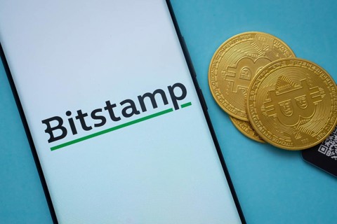 Dhaka, Bangladesh- 03 Sep 2025: Bitstamp logo on smartphone screen near Bitcoin coin and QR code on