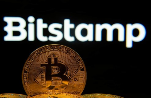 Dhaka, Bangladesh- 03 Sep 2025: Close-up of Bitcoin coins with the Bitstamp logo visible on a