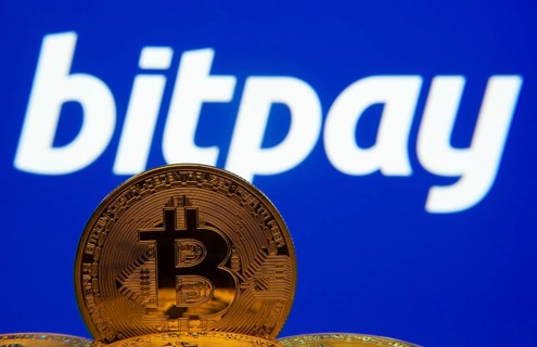 Dhaka, Bangladesh- 26 Aug 2025: Close-up of Bitcoin coins with the bitpay logo visible on a screen