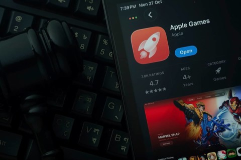 Dhaka, Bangladesh- 28 Oct 2025: An iPad displaying the Apple Games app against a judge's gavel and