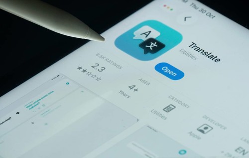 Dhaka, Bangladesh- 30 Oct 2025: Apple Translate app on a iPad screen with a pen pointing at the