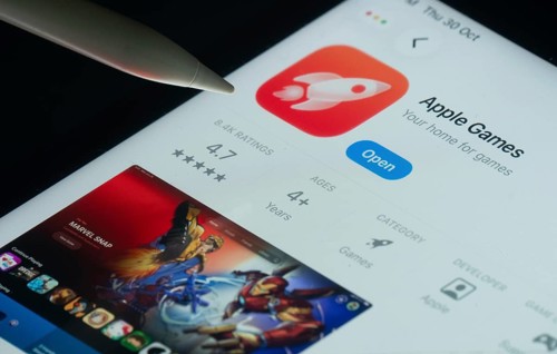 Dhaka, Bangladesh- 30 Oct 2025: Apple Games app on a iPad screen with a pen pointing at the install
