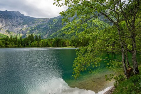 Landscape of Lake Offensee after rain when the sun comes through the clouds in spring,