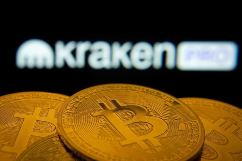 Dhaka, Bangladesh- 01 Nov 2025: Close-up of Bitcoin coins with the Kraken Pro logo visible on a