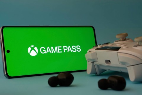 Dhaka, Bangladesh- 15 July 2025: A smartphone with a Xbox Game Pass icon next to a controller and