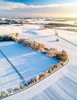 Bird Eye Perspective of Frost Covered Farmland. Seasonal Agricultural Scenery, winter and autumn