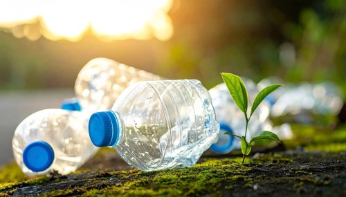 Crushed plastic water bottle waste in a wild landscape, symbol for nature protection, waste