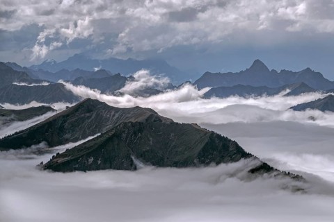 View from the Nebelhorn summit to mountains of the Allgäu Alps, mountains rising from fog in the