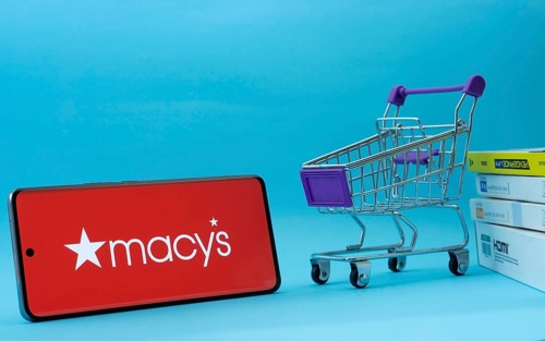 Dhaka, Bangladesh- 03 July 2025: Smartphone with Macy's logo next to a small shopping cart and