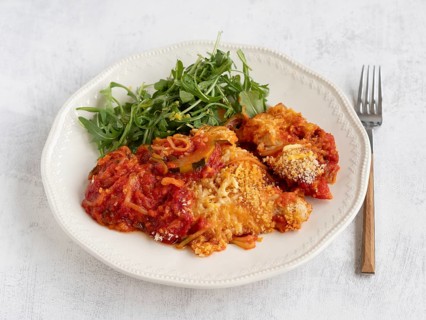 Enjoying a healthy and delicious meal of courgette spaghetti with tomato sauce, parmesan cheese,