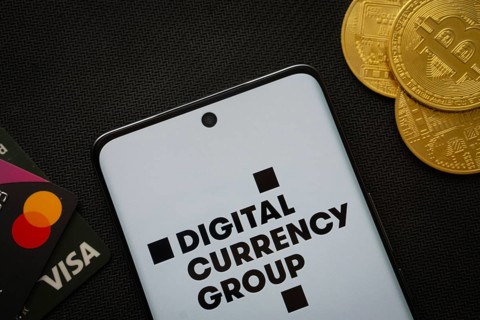 Dhaka, Bangladesh- 03 Oct 2025: Smartphone displaying Digital currency group logo surrounded by