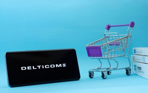 Dhaka, Bangladesh- 03 Oct 2025: Smartphone with Delticom logo next to a small shopping cart and