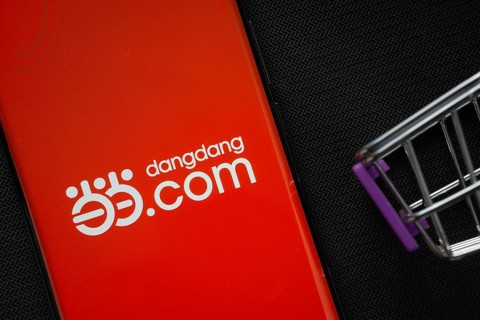 Dhaka, Bangladesh- 03 Oct 2025: A smartphone displaying the Dangdang.com logo next to a miniature