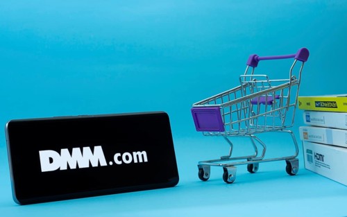 Dhaka, Bangladesh- 03 Oct 2025: Smartphone with Dmm.com logo next to a small shopping cart and