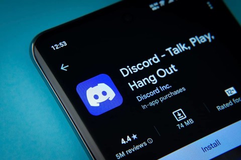 Dhaka, Bangladesh- 03 Oct 2025: On a blue surface, a smartphone displays the Discord app within the