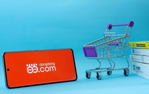 Dhaka, Bangladesh- 03 Oct 2025: Smartphone with Dangdang.com logo next to a small shopping cart and