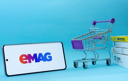 Dhaka, Bangladesh- 03 Oct 2025: Smartphone with Emag logo next to a small shopping cart and boxes