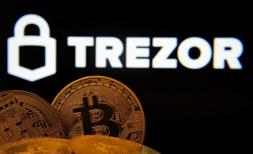 Dhaka, Bangladesh- 30 Sep 2025: Close-up of Bitcoin coins with the Trezor logo visible on a screen